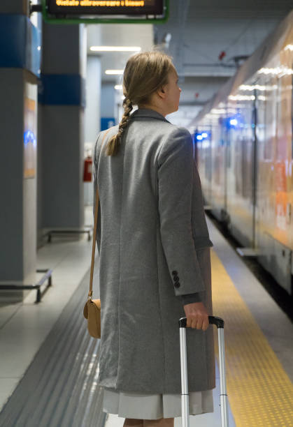 istock Business lady is waiting for a train at the station. 1168356754