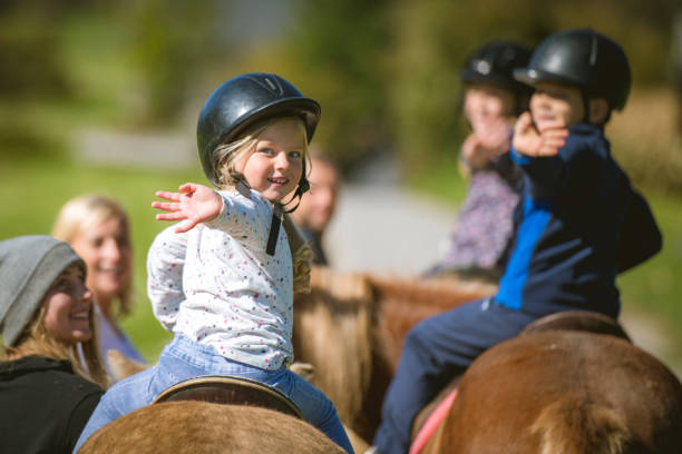 Children training horseback riding stock photo
