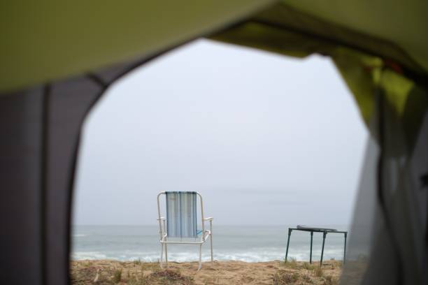 View of beach through camping tent entrance stock photo