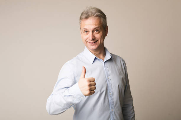 istock Happy man showing thumbing up and smiling 1168361592