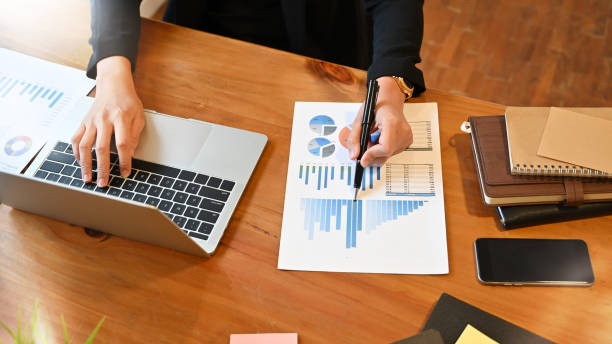 istock Top view financial people working with paper document chart and laptop. 1168363911
