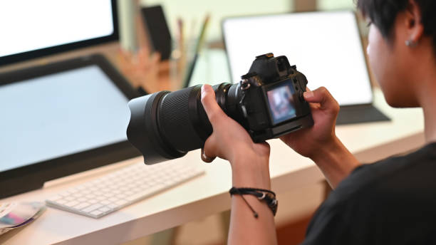 istock Cropped shot cameraman working and checking on camera. 1168363962