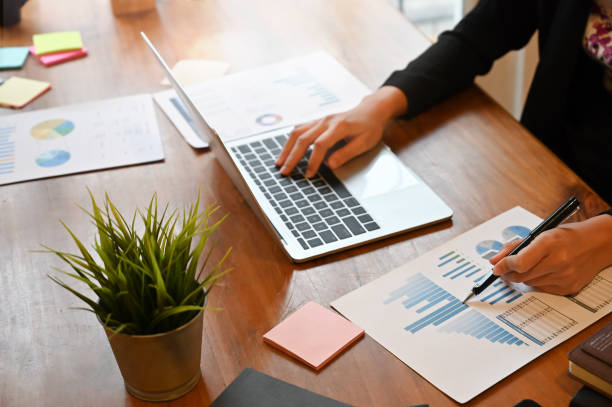 istock Top view financial people working with paper document chart and laptop. 1168363973