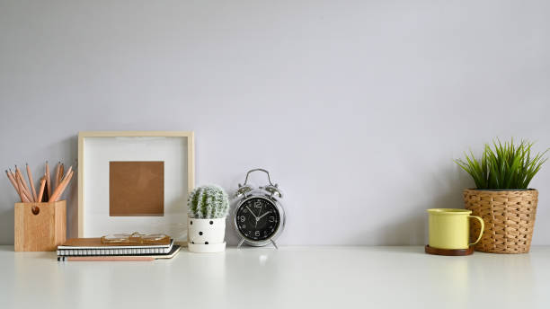 istock Copy space workspace with photo frame, coffee, plant decoration, pencil on office desk. 1168364009