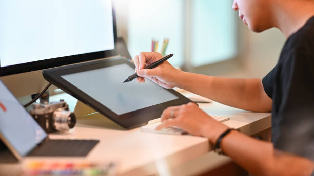 istock Young graphic designer working with pen and tablet, young artist working with creative workplace. 1168364034