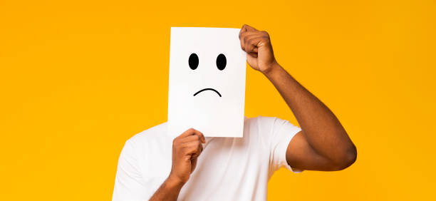istock Black man holding paper with sad face 1168364051