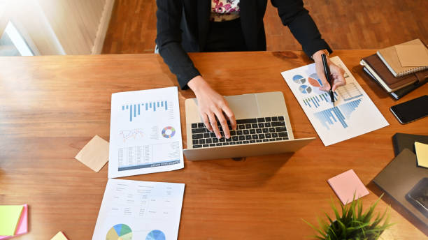 istock Top view financial people working with paper document chart and laptop. 1168364108