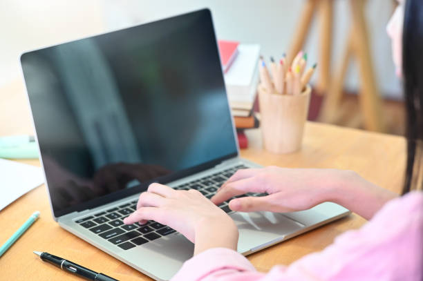 istock Cropped shot female student hands using laptop computer on wood table. 1168364142