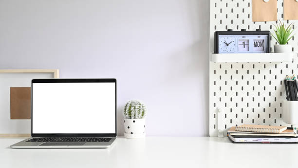istock Workspace computer, Empty screen laptop and office supplies on white office desk. 1168364144