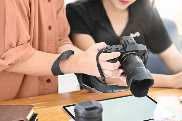 istock Creative meeting her professional camera photographer working on desk. 1168364147