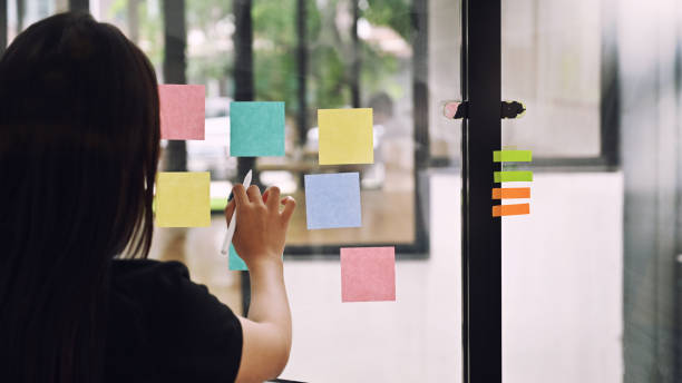 istock Behind shot Female meeting and use post it notes to share idea her on sticky note. 1168364151