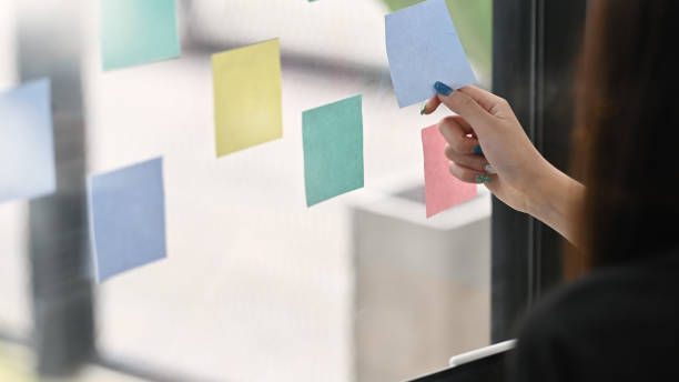 istock Sticky note paper reminder young woman share idea on sticky note. Discussing - business. 1168364154