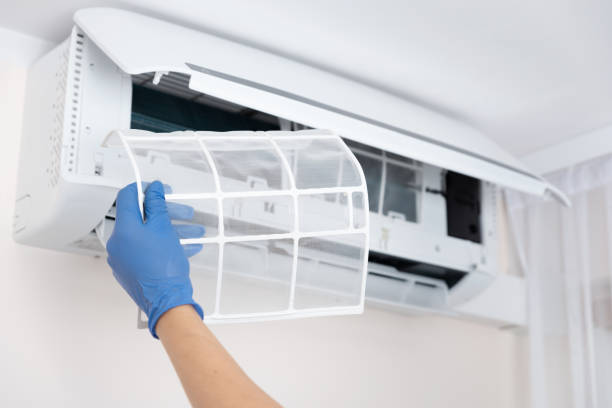Technician cleaning air conditioner filter Technician cleaning air conditioner. Hand holding air conditioning filter adjusting photos stock pictures, royalty-free photos & images