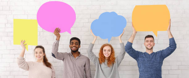 istock Friends holding speech bubbles and looking at camera 1168365586