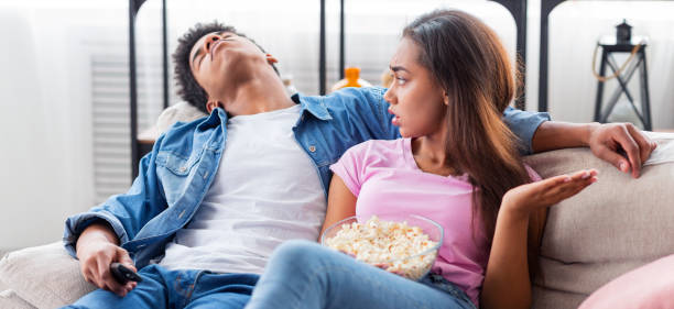 istock Black guy fell asleep during watching boring movie at home 1168366311