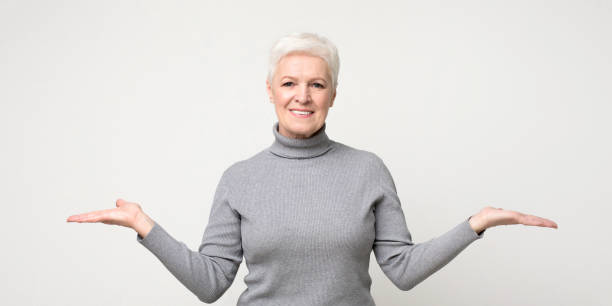 istock Mature woman comparing variants, making scales with her empty arms 1168366424