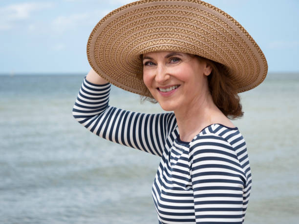 istock Mature woman with beach hat 1168366482