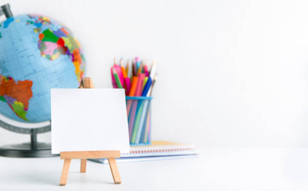 istock Easel with blank space and world globe on white background 1168366778