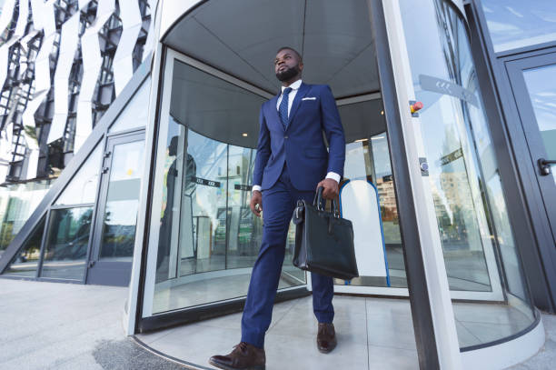 istock Confident Afro Businessman With Briefcase Leaving Modern Office Building 1168368022