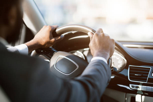istock Perfect feeling. Businessman holding steering wheel, free space 1168368059