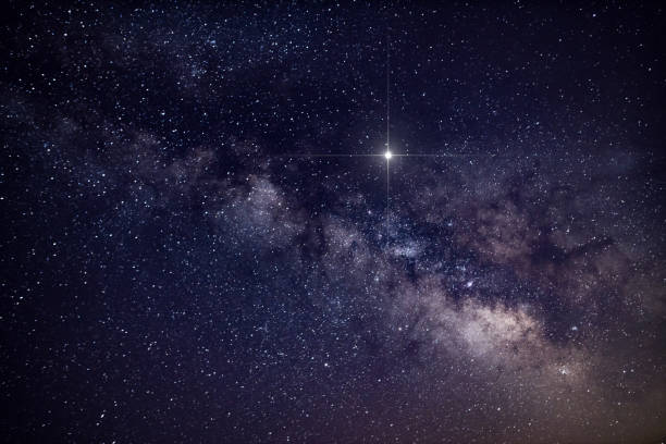 istock Abstract background with spike glowing lucky star and Milky Way Galaxy during clear summer night - creative stock image 1168370264
