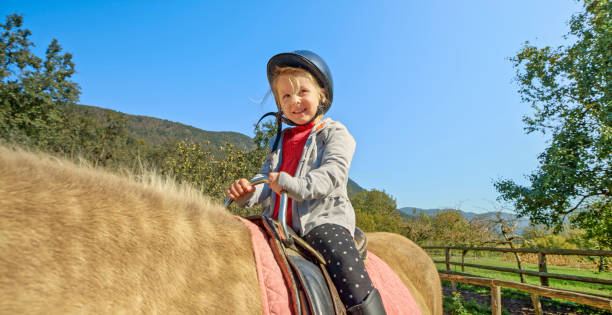 istock Girl sitting on horse 1168371110