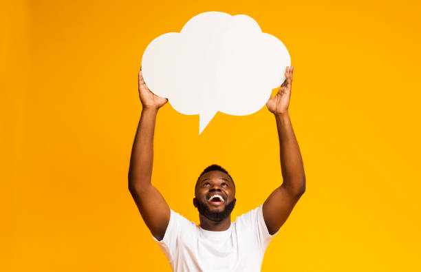 istock Happy black man holding blank speech bubble above his head 1168371166