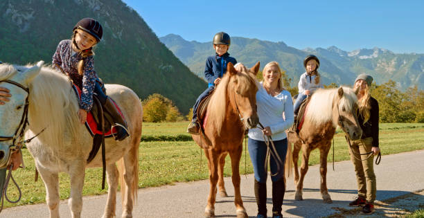 istock Children sitting on horse 1168371236