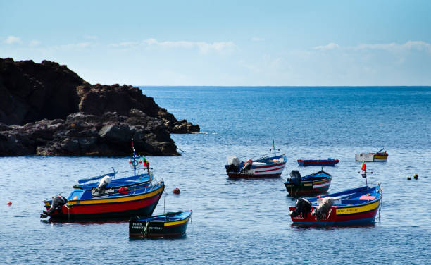 A bay in a small location where fisher do their work. Camara de Lobos, Madeira, Porugal, Europe, many tiny collored fisherboats stock photo