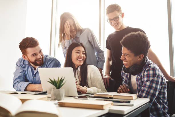 istock Happy friends laughing, preparing for lectures in library 1168371393