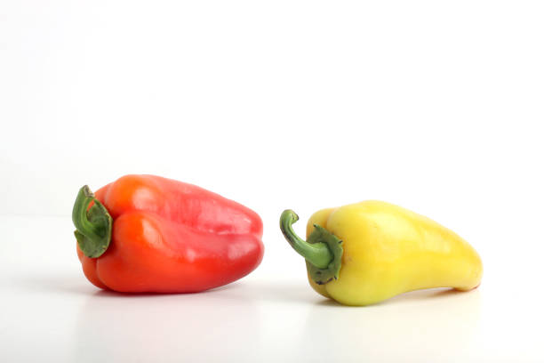 two sweet peppers isolated on white background. Image contains copy space