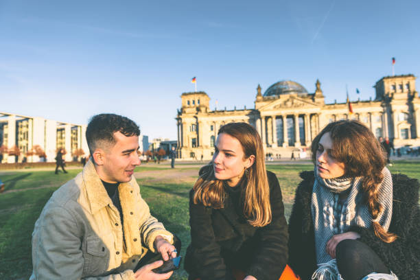 istock three young people sitting in front of Berlin Reichstag 1168371649