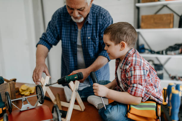 istock Grandson helping grandfather crafting 1168371667