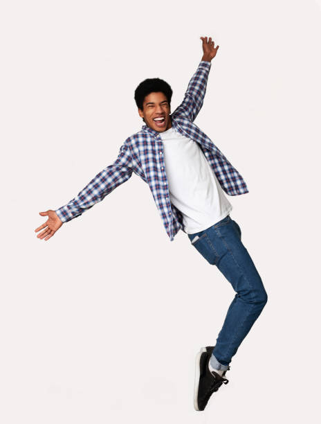 istock Funny Black Guy Fooling, Standing on Sneakers Toes 1168372557