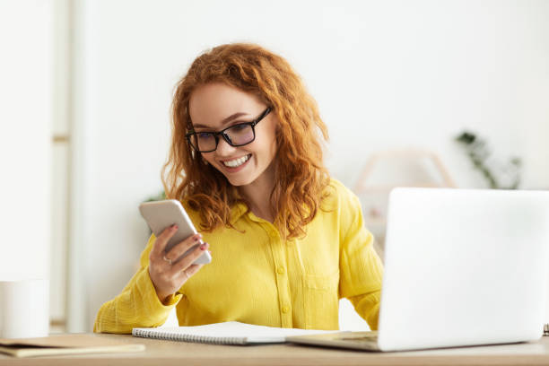 istock Businesswoman checking message on cellphone, working on laptop 1168373105