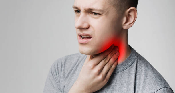 young man suffering from tonsillitis, pulping his neck - pulping imagens e fotografias de stock