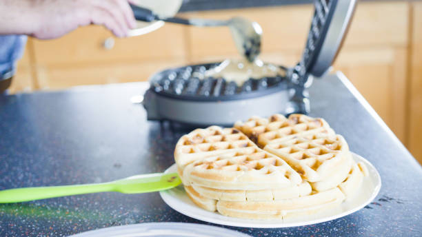istock Making homemade waffles in an electric waffle maker. 1168373985