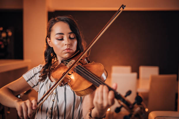 istock Young woman musician playing violin 1168375564