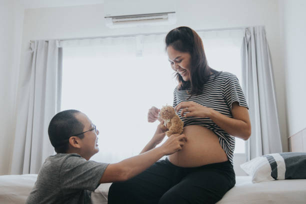 We are going to be father and mother for our baby Family, togetherness, love, Abdomen, Adult, Adults Only, care bear stomach stock pictures, royalty-free photos & images