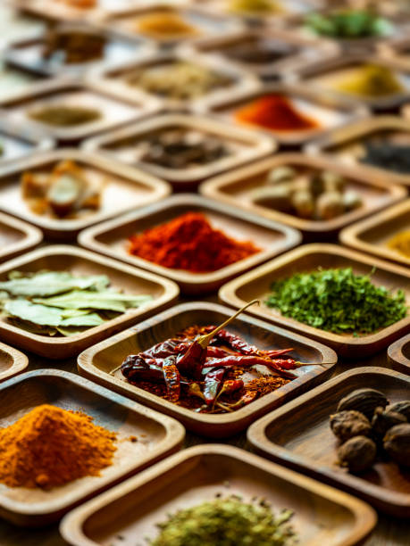 Variety of colorful, organic, dried, vibrant Indian food spices in wooden trays on an old wood background. Many colorful, organic, dried, vibrant Indian food, ingredient spices displayed in wooden trays on an old wooden background. Shot from a high angle, nice color contrast. Shallow depth of field. healthy indian food stock pictures, royalty-free photos & images