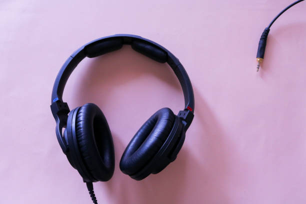 istock Music headphones on pink background seen from above, musical objects 1168378733