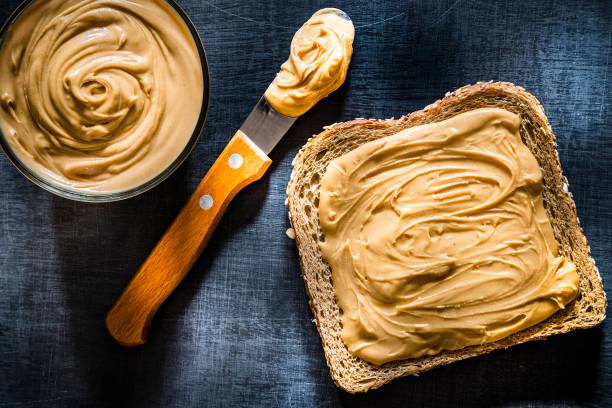 istock Peanut butter scattered on a slice of bread 1168380235