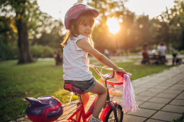 istock Beautiful girl riding bicycle in park 1168380820