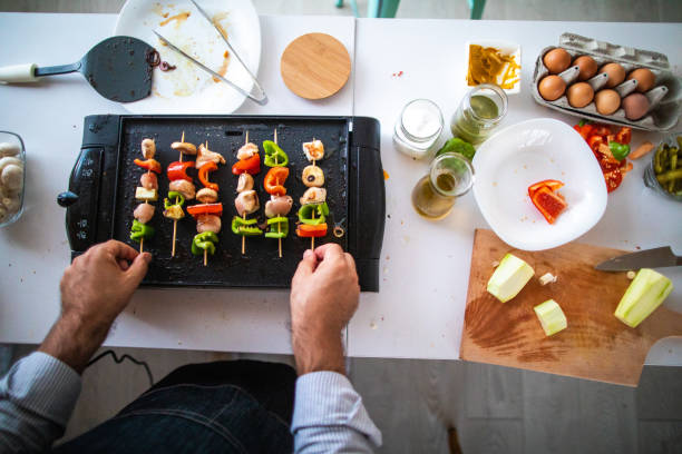istock Skewers with meat and vegetables on electrical barbecue 1168381407