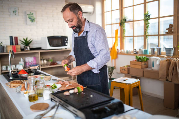 istock Preparing dinner for his friends at home 1168381515