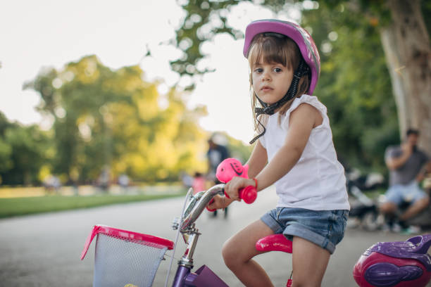 istock Cute little girl riding a bicycle 1168382184