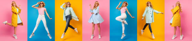 Woman Jumping And Having Fun Against Colorful Backgrounds