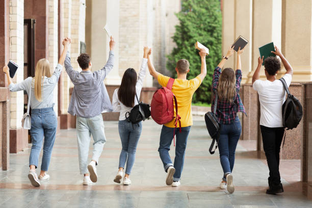 istock Students walking in college campus after passing test 1168384508
