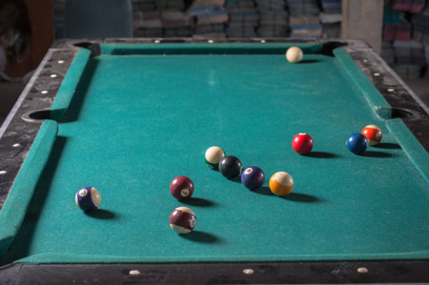 istock Billiards balls and cue on billiards table. Billiard sport concept 1168385598