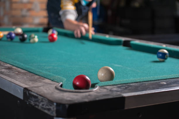 istock Billiards balls and cue on billiards table. Billiard sport concept 1168385676